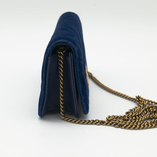 Navy blue handbag with a gold chain on a white background
